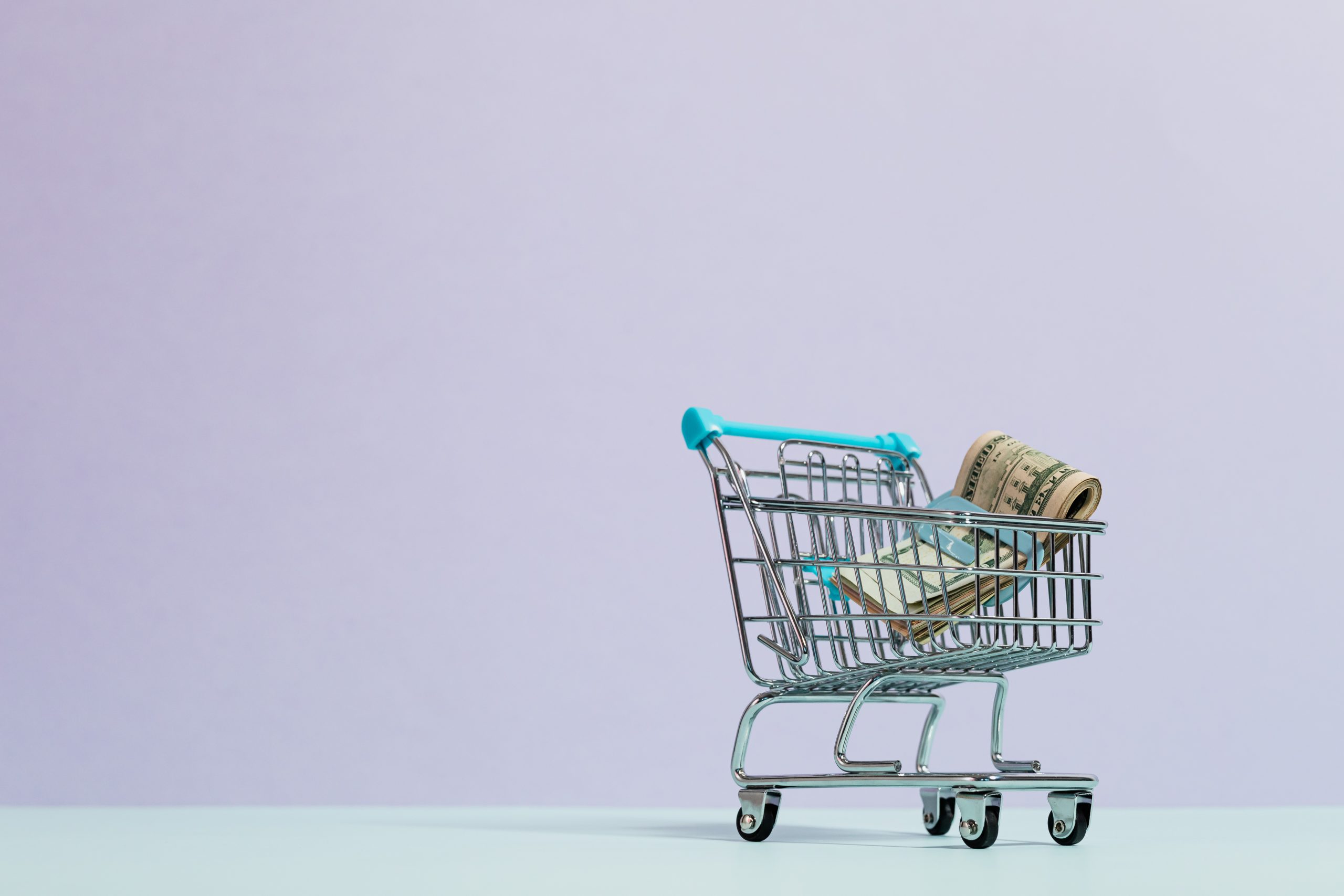 Cash inside a tiny shopping cart