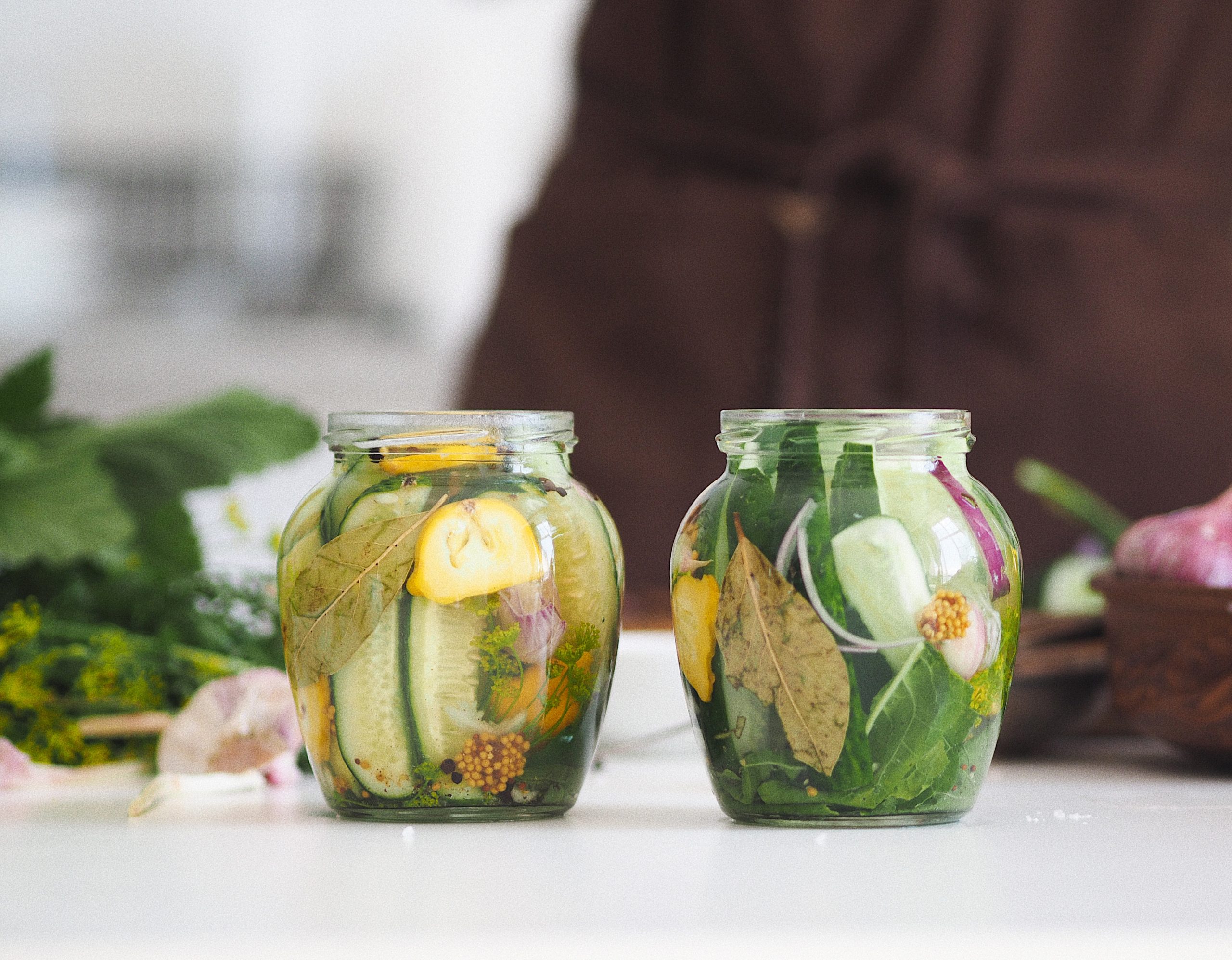 Clear glass jar with green leaves and vegetables